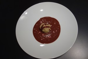 Sweet matzo ball with chocolate sauce and crushed candy cane.